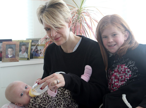 Emma helping Tina with the baby